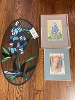 Stained glass panel and two framed watercolor prints grouped