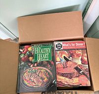 Open box showing The Healthy Heart Cookbook and What’s for Dinner? Meal-Planning Cookbook