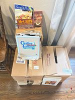 Entire lot showing cookbooks stacked on boxes with recipe binders and clippings