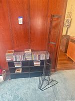 Overall view showing CD shelving unit filled with CDs and separate tall tower rack
