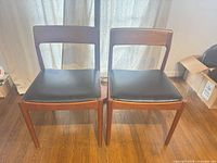 Front view of two teak side chairs
