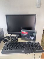 Front view of monitor, keyboard, mouse, sealed router box