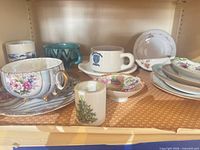 All items on shelf showing teacup, toothpick holder, mugs, Rice cup and assorted saucers