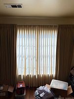 Full window showing outer drapes and inner semi-sheer liners, floor length