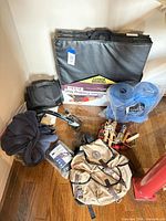 Overall lot view showing folding mat, barbells package, bags, robe, jump rope, hand exerciser
