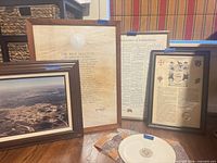 Group shot of four framed prints and plate