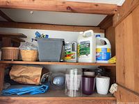 shelf with planters, cleaners, baskets, tarp