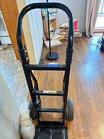 Front view of black Harper dolly with wheels and toe plate