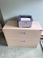 Steelcase tan lateral file cabinet with Brother printer on top