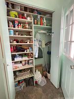 Full view of closet with shelves of supplies and cleaning tools