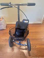 Front view of black KneeRover knee scooter with basket and handlebars