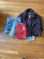 Group shot showing packaged garments and open coat