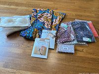 All items laid out: bras, Zurl dress, Berkshire hosiery, Tencel packages, wallet
