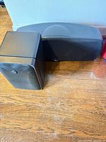 Klipsch centre speaker beside Braun compact speaker