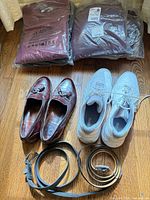 Entire lot overview: bagged clothing, loafers, Reebok shoes, belts