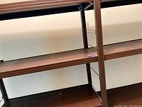 Full view of unit showing metal frame and laminate shelves