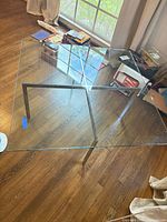 Top view of square glass table showing full shape and chrome base