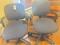 Two matching office chairs side by side showing overall design