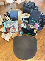 Overall lot showing seat cushion, portfolio cases, binders and supply boxes