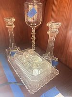 Pair of candlesticks flanking tray filled with stoppers