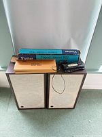 Two Pioneer speakers with Vivitar tripod box and Kodak scanner on top