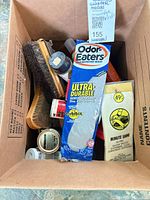 Box overview showing insoles, Minute Shine pack, brushes, polish tins