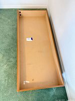 Inside view of empty drawer showing MDF bottom and particle-board sides