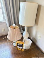 Group shot showing tall ceramic lamp, smaller lamp, boxed lamp, and Bertrand ice bucket