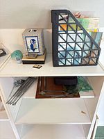 Shelf with magazine holder of maps, drafting tools, decor items