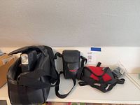 Overall view of RCA camcorder in bag, Pentax case, Zing pouch, sealed strap