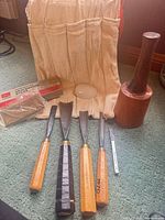 Group shot of chisels, mallet, stones, and canvas apron