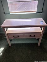 Front view of white solid wood accent table