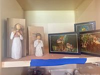 Shelf view showing both Willow Tree figurines and three owl wood art pieces