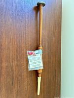 full view of wooden practice chanter hanging vertically