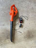 Full view of Black+Decker leaf blower with battery and charger