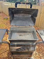 Open grill showing interior cooking grates and lid