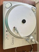 Top view of ION iTUSB turntable showing platter, slipmat, tonearm, controls and branding