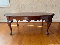 Front angled view showing overall table design and carved legs