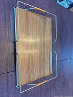 Top view of rectangular tray showing wood veneer surface within metal frame