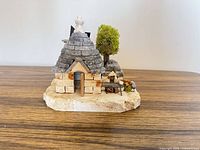 Front view of miniature stone Trullo hut on stone base