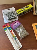 Craft supplies including linoleum cutter box, stamp set, paint markers and jewelry findings