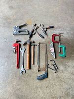 overhead view of entire hand tool lot on concrete floor