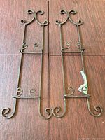 Both metal brackets side by side on flat surface