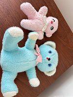 Blue and pink plush bears on tabletop
