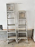 Front view of both aluminum folding stepladders showing height and step count