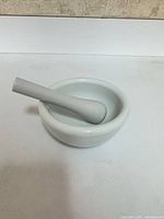 mortar with pestle resting inside showing overall set