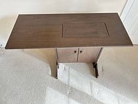 Top view of closed cabinet showing dark brown veneer and centre hatch outline