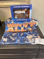 Bobblehead box and rally towel displayed together