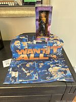 Bobblehead in box and rally towel displayed together