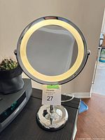 Front view showing lighted ring and chrome stand